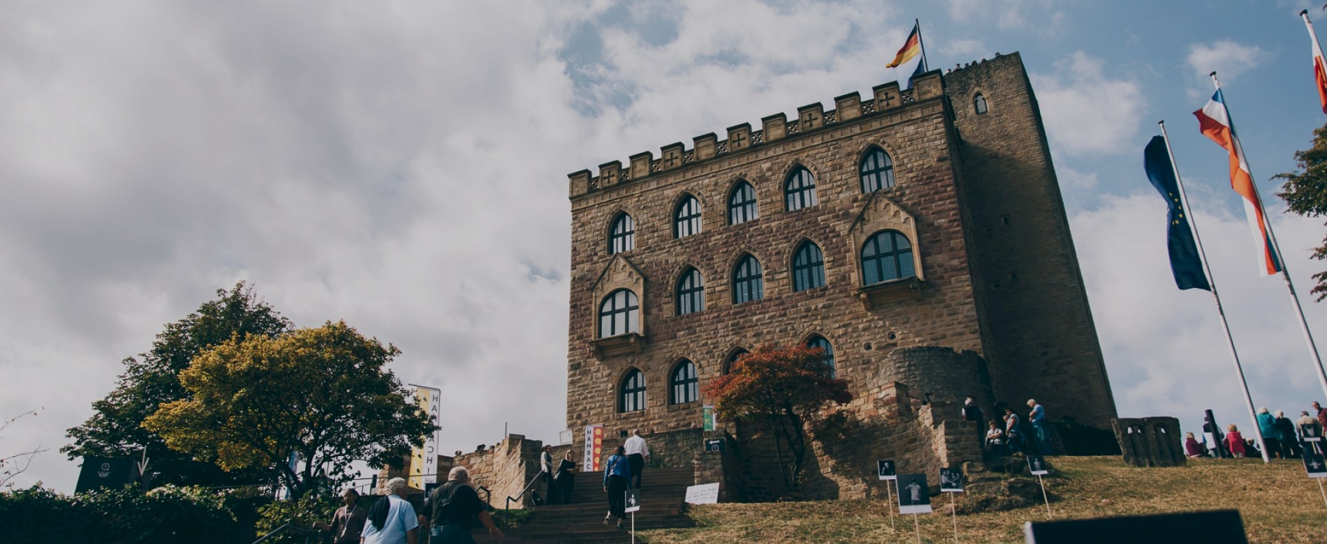 People visit a castle on a hill.